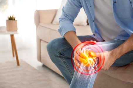 Man holding Knee that is glowing red